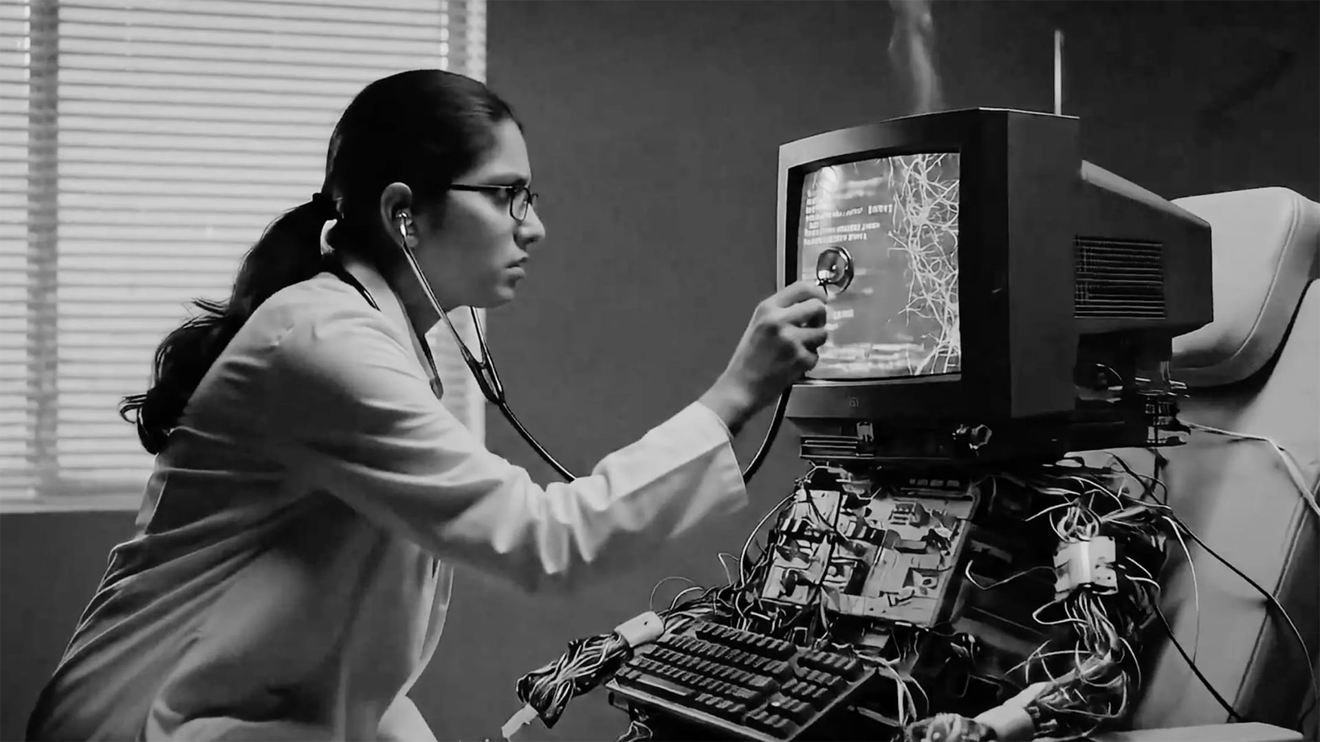 Physician working with obsolete technology representing legacy healthcare systems